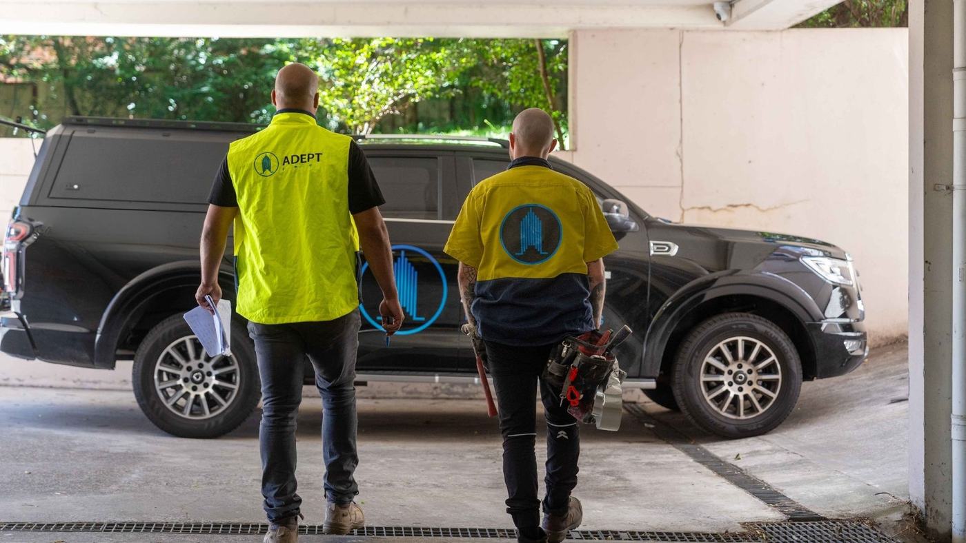 Adept technicians walking to a service vehicle
